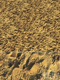 Wet sand material with footprints